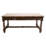 A Victorian Carved Oak Dining Table, mid 19th century, the boarded top with cleated ends and