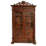 A Late 19th Century Oak Display Cabinet, with a scrolled pediment above an acanthus leaf decorated