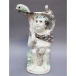 An Early 19th Century Creamware Toby Jug, moulded as Bacchus seated on a barrel of wine with a satyr