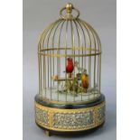 A 20th Century Singing Bird Cage Automaton, decorated with cherubs, 28cm high Paint original.