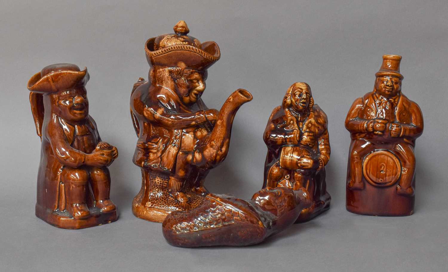 Treacle Glazed Pottery, 19th century, including Toby Jug, mermaid form flask, figural teapot etc (