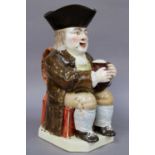 A 19th Century Staffordshire Pottery Toby Jug, of large size, coloured in enamels, 30cm highFrom the