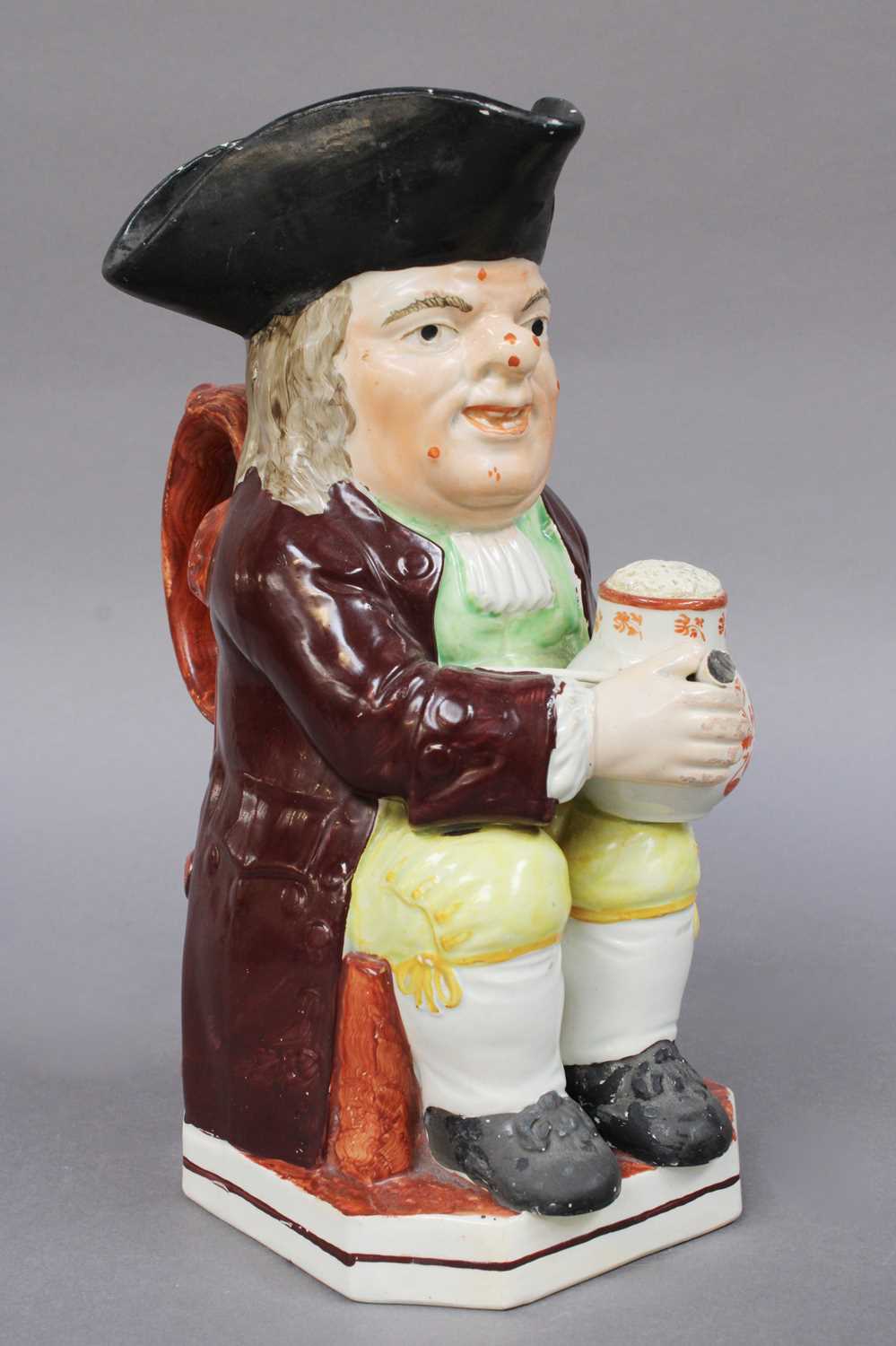 An Early 19th Century Pearlware Toby Jug, moulded with a mug of ale and clay pipe, painted in