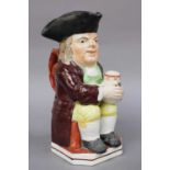 An Early 19th Century Pearlware Toby Jug, moulded with a mug of ale and clay pipe, painted in
