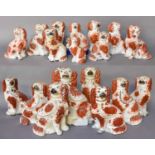 A Collection of 19th Century Staffordshire Seated Spaniels, all red and white glazed including and