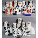 A Group of 19th Century Staffordshire Seated Spaniels, including examples with Disraeli curls,