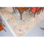 A Chinese 'Savonnerie' Carpet, the mint green field with floral medallion framed by ivory borders,