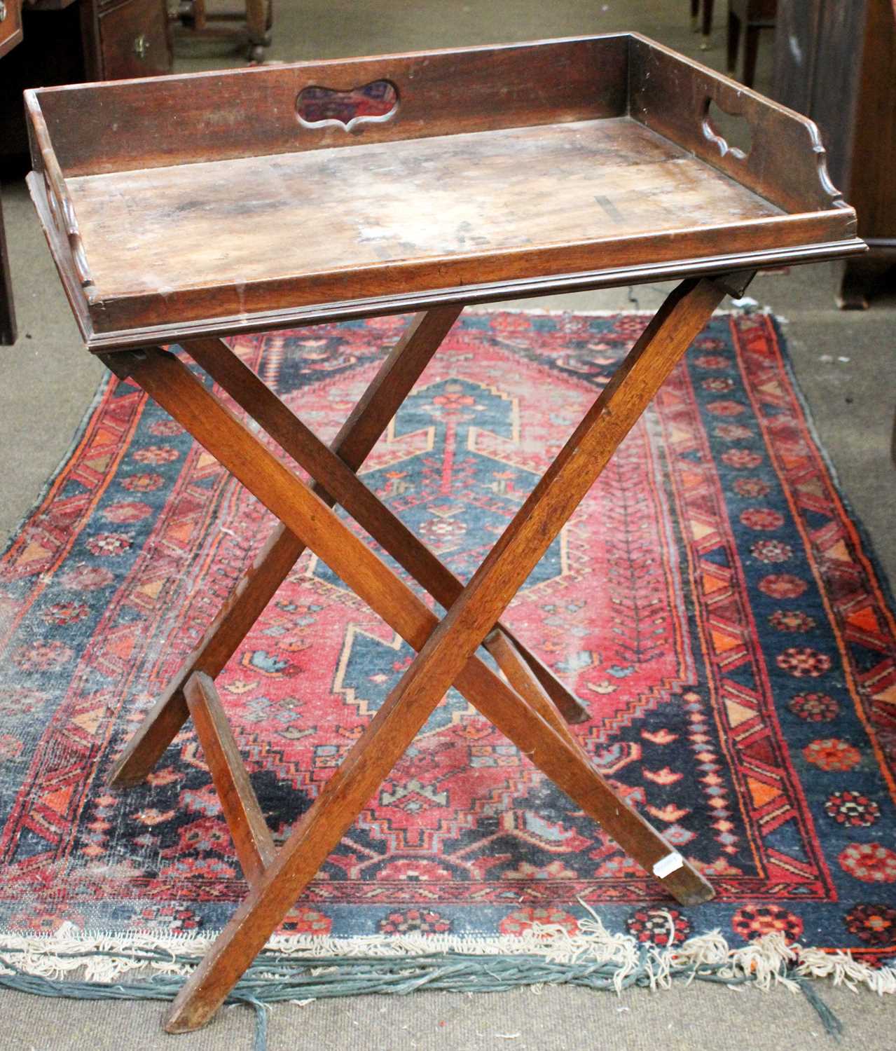 A 19th Century Mahogany Butlers Tray, on folding stand, 65cm by 50cmThe tray with two cracks running