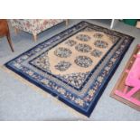 A Chinese Rug, 20th century, the ivory field with five roundels framed by spandrels, and royal