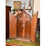 A Carved Wood Crucifix, within an oak two door wall mounted cabinet, with brass strap work, 37cm
