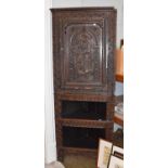 A Victorian Carved Oak Standing Corner Cupboard, the upper section decorated with a dragon, 73cm