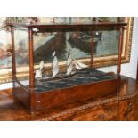 A Model of a Triple Masted Ship in Rough Seas, housed within a glazed mahogany cabinet, 76cm by 40cm