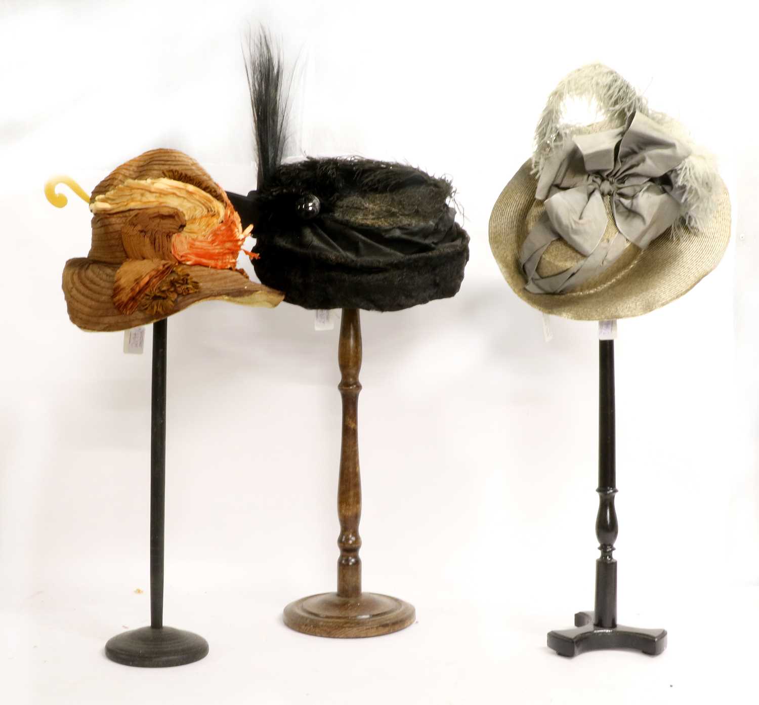Three Early 20th Century Hats comprising an Au Bon Marche Paris straw hat with grey ribbon,