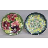 A Modern Moorcroft Plate, Clematis pattern, with Moorcroft stamp to base, together with another,