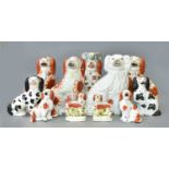 Seventeen Victorian Staffordshire Pottery Spaniels, including begging Spaniel jug, small pair