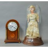 An Edwardian Mahogany Striking Mantel Clock; Wax Doll under dome and a gilt metal equestrian plaque
