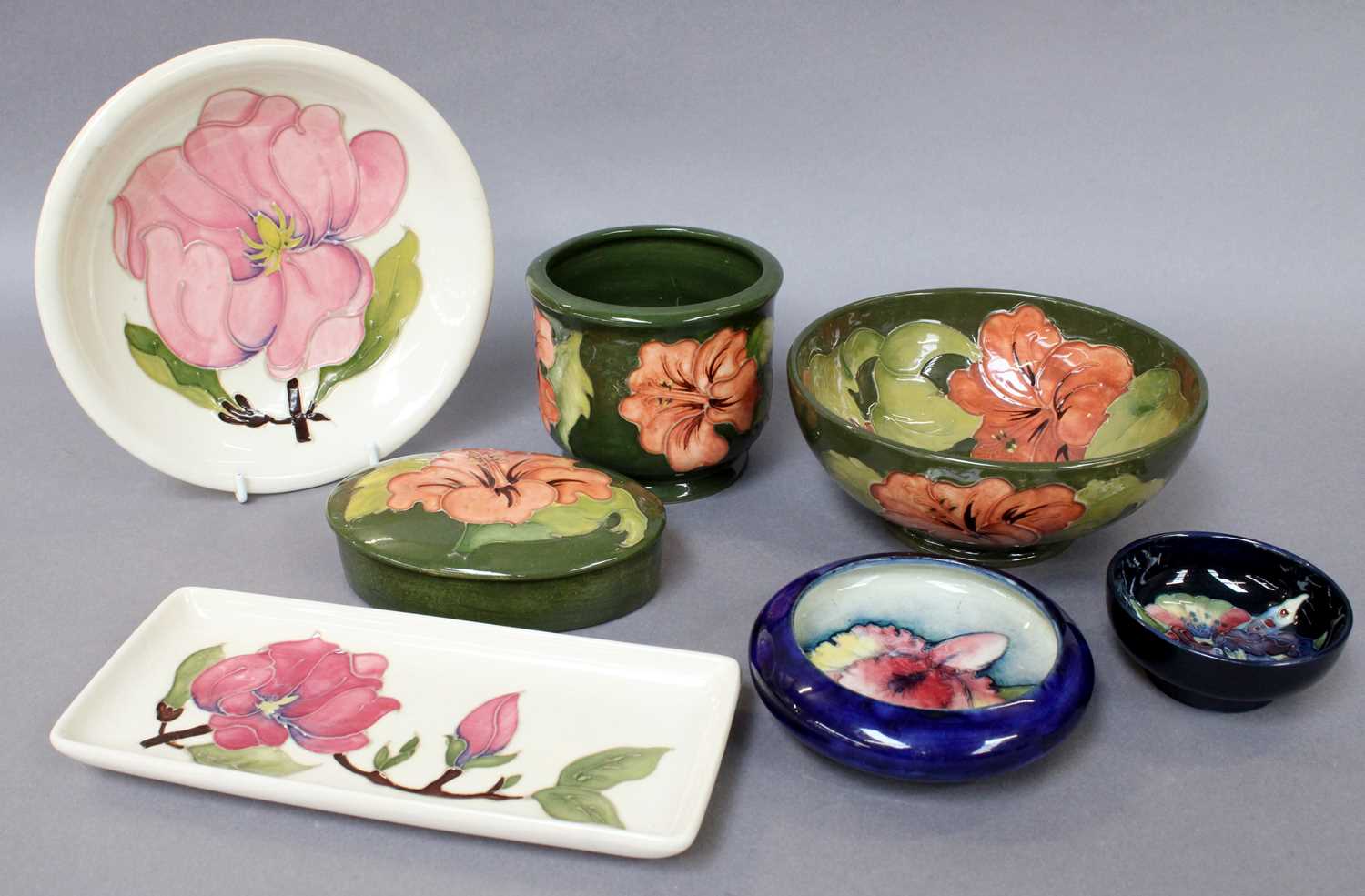 A Collection of Moorcroft Pottery, comprising two Orchid pattern dishes, a green ground Coral