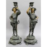 A Pair of Parcel Gilt Bronzed Candlestick Figures