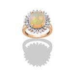 A 9 Carat Gold Opal and Diamond Cluster Ring, the oval cabochon opal in a yellow four claw
