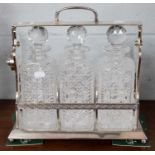 A Betjemanns Patent Silver Plated Three Bottled Tantalus, with a set of three cut glass decanters,No