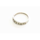 A Diamond Half Hoop Ring, the round brilliant cut diamonds in white claw and channel settings, to