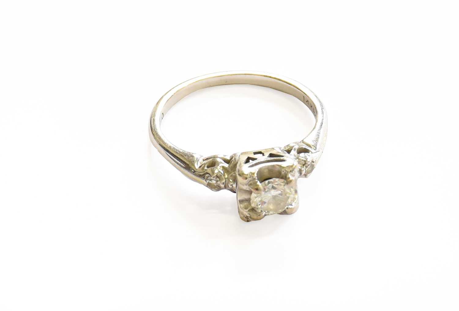 A Diamond Solitaire Ring, the round brilliant cut diamond in a white claw setting, to eight-cut