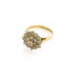 An 18 Carat Gold Diamond Cluster Ring, the central round brilliant cut diamond within a double