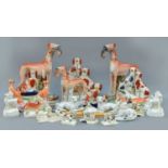 A Group of Victorian Staffordshire Pottery Models of Dogs, including a pair of spaniels on a barrel,