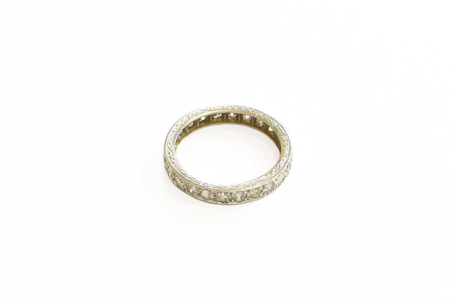 A Diamond Eternity Ring, the eight-cut diamonds in white claw and channel settings, total