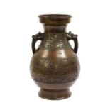 A Chinese Bronze Vase, in Archaic style, of baluster form with mask handles, worked with bands of