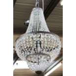 A Chandelier of Tent and Bag Form, with silvered frame and having graduated glass drops,