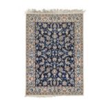 tNain Rug, Central Iran, circa 1970, The indigo field of vines and palmettes enclosed by ivory