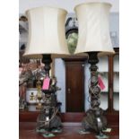 A Large Pair of Patinated Metal Table Lamps, the multi knopped pedestals on tripod-shaped bases,