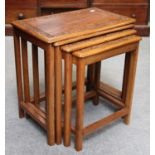 A Nest of Four Carved Teak Tables, largest, 53cm by 32cm by 53cm