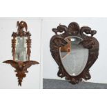 A Carved Oak Wall Mirror, in the Austro-German style, decorated with eagles, 123cm and Another, of