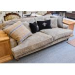 A Modern Grey Upholstered Three Piece Suite, comprising: A Four Seater Sofa, 253cm, A Three Seater