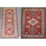 Afghan Rug, The blood red field with three medallions framed by ivory borders, 156cm by 104cmAnother