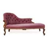 A Victorian Walnut Chaise Longue, upholstered in purple fabric with padded back and seat, raised