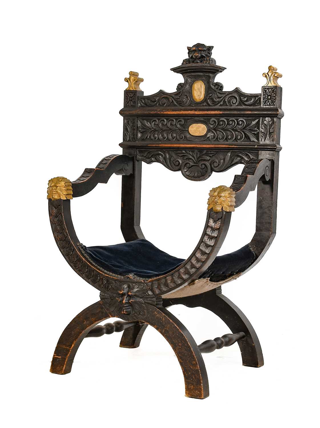 A Victorian Carved Oak and Parcel Gilt Savonarola Style Armchair, late 19th century, the carved back