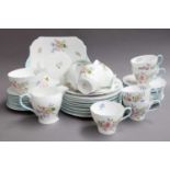 A Shelly Part Tea Set in the "Wild Flowers" Pattern, including trios, milk jug, sugar bowl, bread