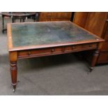 A William IV Mahogany Library Table, with green leather top and four drawers, on tapering