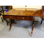 A George III Mahogany Sofa Table, with brass paw feet moving on castors, 149cm (open) by 82cm by