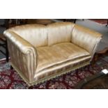 A 19th/20th Century Howard Style Two-Seater Sofa, on short mahogany legs and castors, covered in a