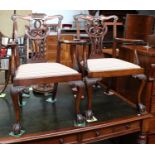 A Pair of 19th Century Carved Mahogany Open Armchairs, each with a yoke crest rail above a pierced
