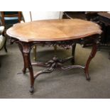 A French Kingwood Centre Table, the shaped oval top with a carved and pierced apron on further