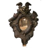 An 18th Century Painted and Parcel-Gilt Carved Wood Mirror, the small oval mirror plate within a