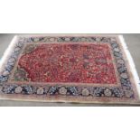 An Indo-Persian Rug, the blood field with birds amongst vines within narrow conforming borders,