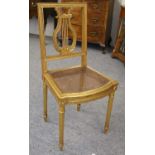 An Early 20th Century Gilt Music Room Chair, in Regency style, with lyre formed back and cane