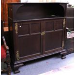 An Early 20th Century Mahogany Sideboard, with scrolling brass strapwork, the top with a recess