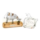 Amanda Bates: Cow Grazing, metal and wood, signed, 24cm long; Douglas Wilson: Boat in a Stormy